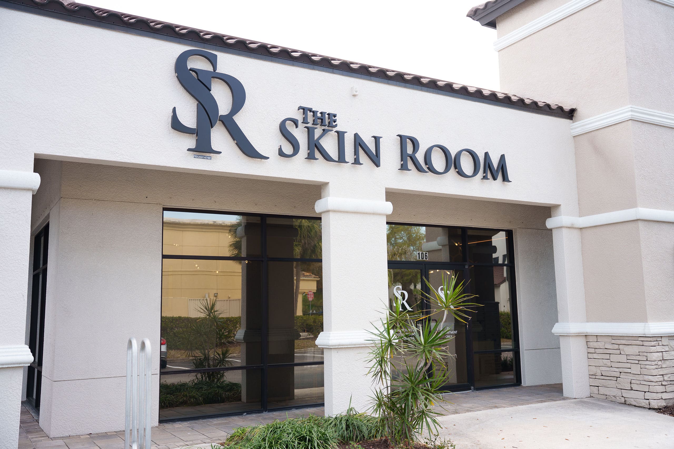 The Skin Room storefront, with the SR sign above the doors